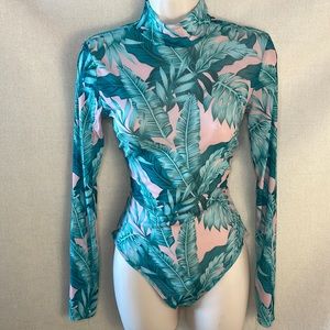 be the center of attention in this stunning sheer/floral print bodysuit